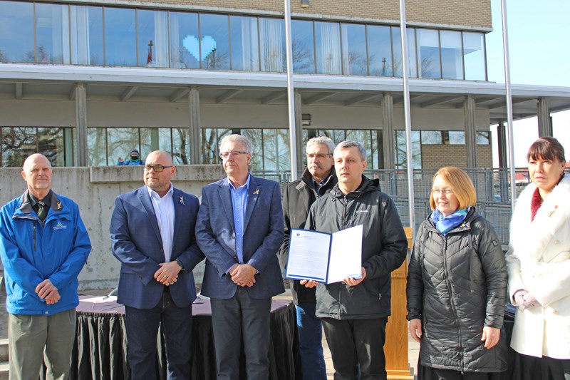 Father Andrii Chornenkyii of the Ukrainian St. George's Catholic Church hold the letter which will be sent to the federal and provincial governments. 