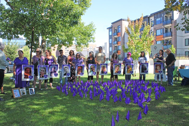 Mothers and family members stand behind those they lost. 