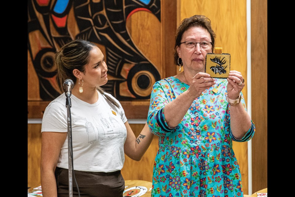 Barb Ward-Burkitt, executive director of the Prince George Native Friendship Centre (PGNFC), right, displays the five millionth moose hide pin that was presented to her by Raven Lacerte, co-founder of the Moose Hide Campaign, during a ceremony at the PGNFC Tuesday to celebrate the milestone that was reached in the 13 years since the campaign was kicked off in November 2011.