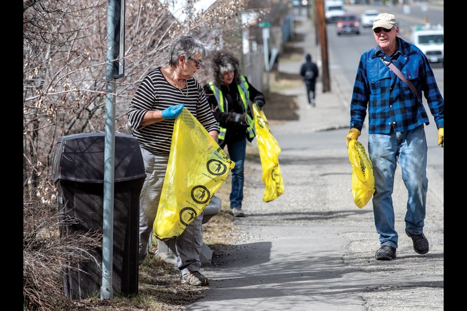 Maj Sutherland, left, Mary-Jane Fournier and Neil Symons work their way along Fifth Avenue from Central to Carney Street Sunday to take part in Spring Clean Up 2024 in Prince George.