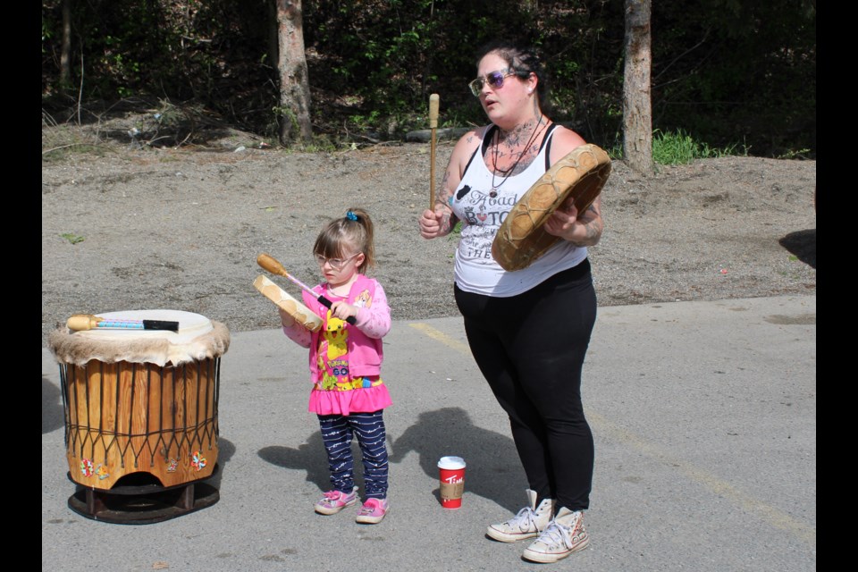 The Suicide Awareness Walk started with a drum circle before heading downtown Prince George. Ali Carriere, left, organizer of the event, sings the traveling song in honour of her father she lost to suicide three years ago while she drums with  three-year-old daughter Galaxy.