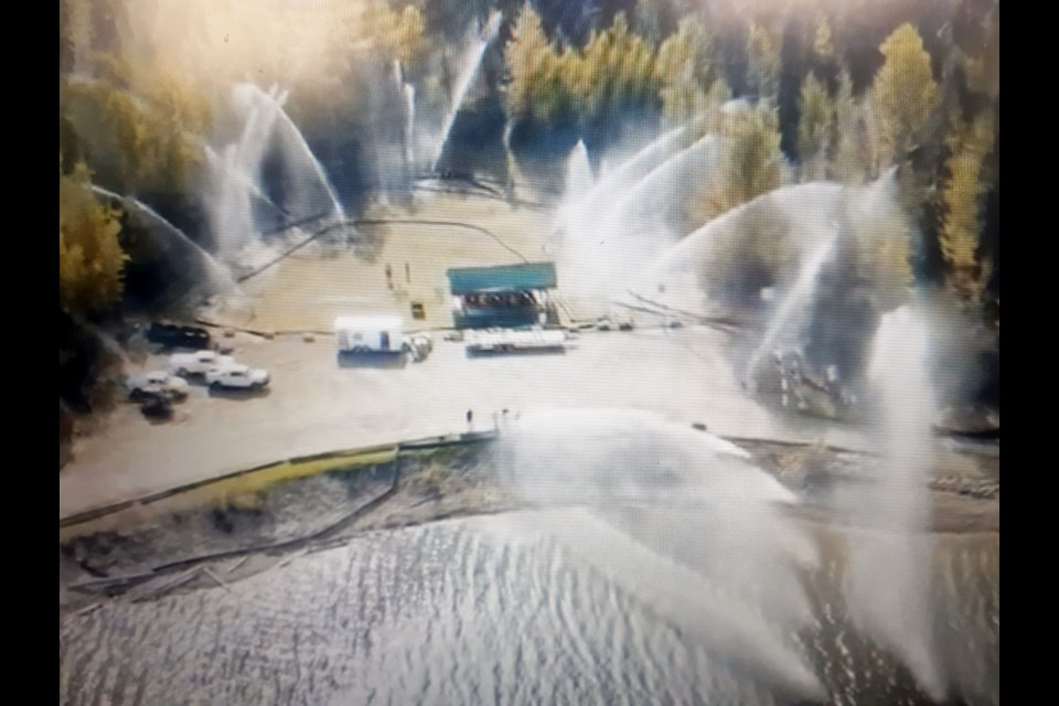 Safeguard, a wildfire fighting company based in Fort St. John, demonstrates how it uses its high-powered pumps and hoses to create a water curtain as a means to protect towns from destruction in wildfires. MLA Mike Morris says it's time the province declared a state of emergency to get resources like Safeguard involved in fighting the fires in B.C.