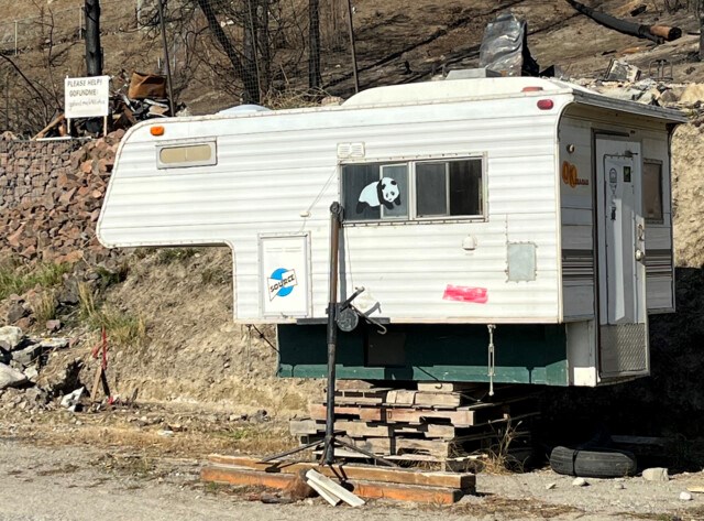 The camper was sitting next to the family's burned out property on Westside Road in Traders Cove.