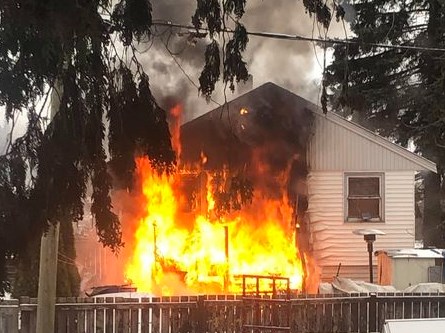 Flames erupt at a 200-block Ewert Street home on Monday morning.