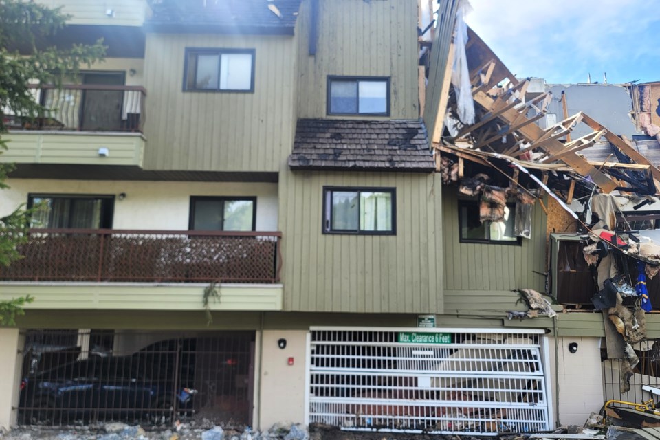 Several vehicles remain parked in the basement garage area buried under debris left from a massive fire that destroyed part of the Boardwalk Apartments complex at 392 Killoren Cres., on Thursday, May 22, 2025