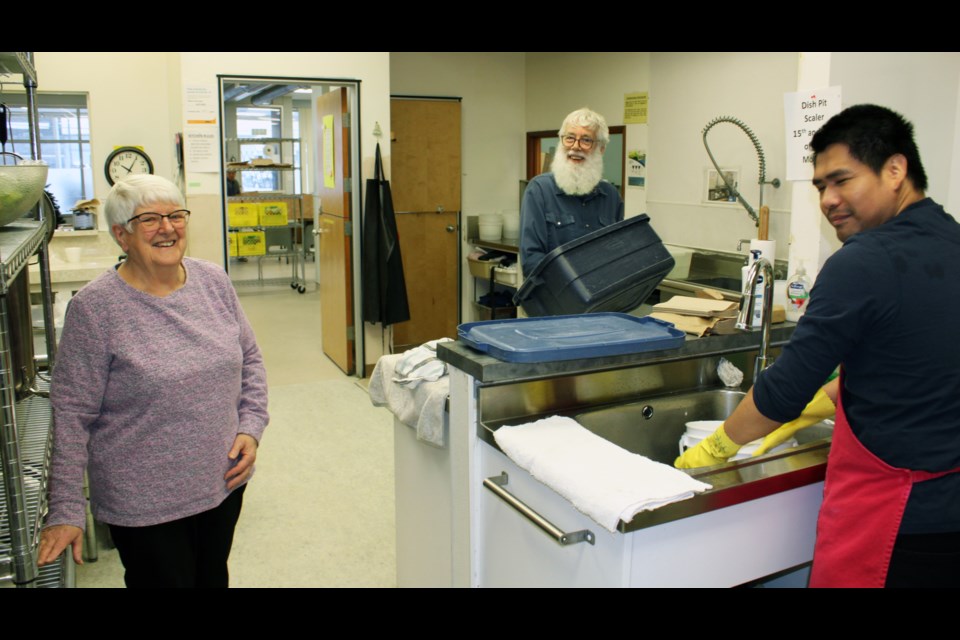 St. Vincent de Paul executive director Bernie Gould has been with the organization for 41 years. She was at the Drop-In Centre Tuesday with volunteer Clint McNeill, centre and assistant coordinator Reiniel Maderal .