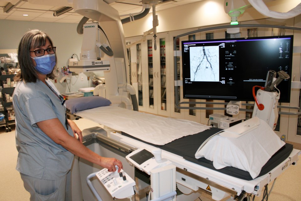 Tracy Van Somer, an interventional radiology technologist at UHNBC, demonstrates the new fluoroscopy x-ray imaging equipment used to provide minimally invasive procedures that cure medical conditions.