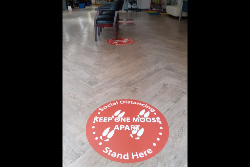 To help remind people at Natsoolyis about social distancing these stickers are on the floor.