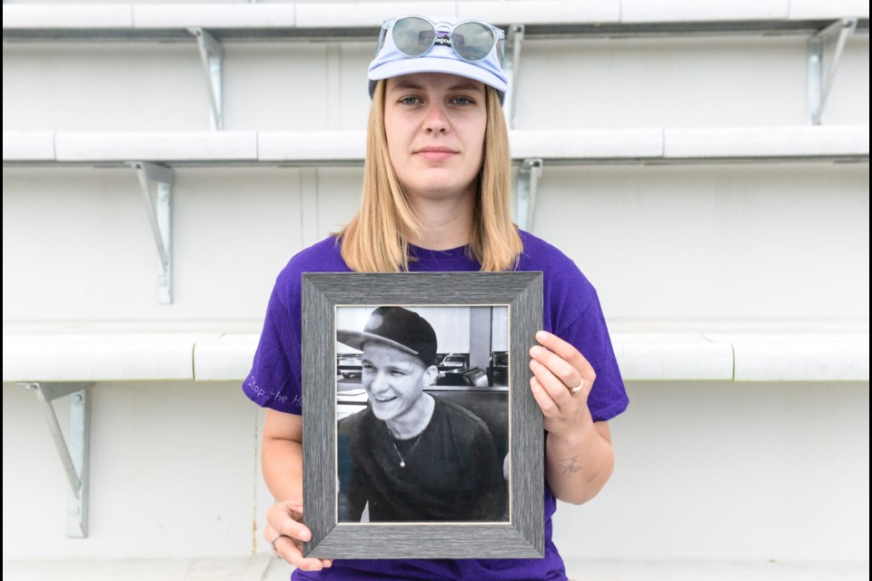 Former UNBC soccer goalie Brooke Molby holds a photo of her late brother Ty, who died of a fentanyl overdose.