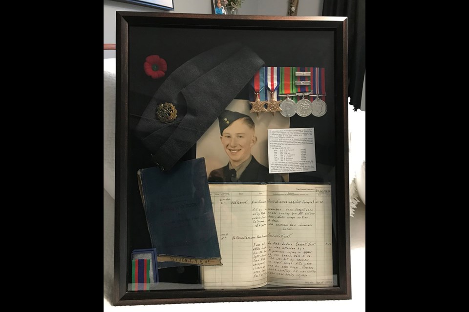 Shannon Studney keeps his father, Warrant Officer Ted Studney’s, photo, medals and flying log in a shadow box.