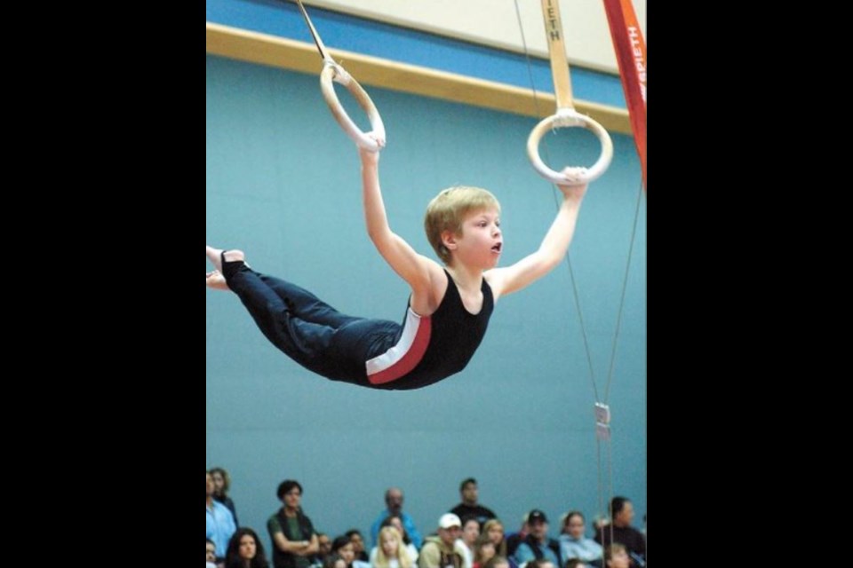 Dave Milne took this great front-page photo for the April 5, 2004, edition of the Citizen of Keylan Norum who took gold on the rings and silver overall for his division.