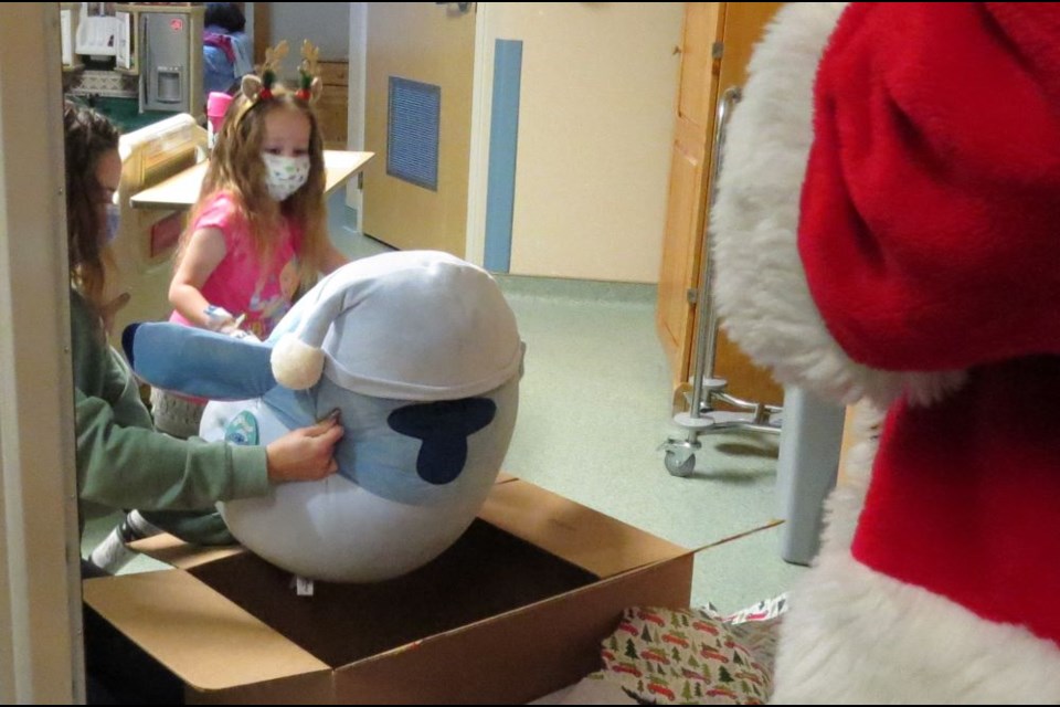 This little girl got a big stuffie from Santa during his visit in the pediatric unit at UHNBC recently.