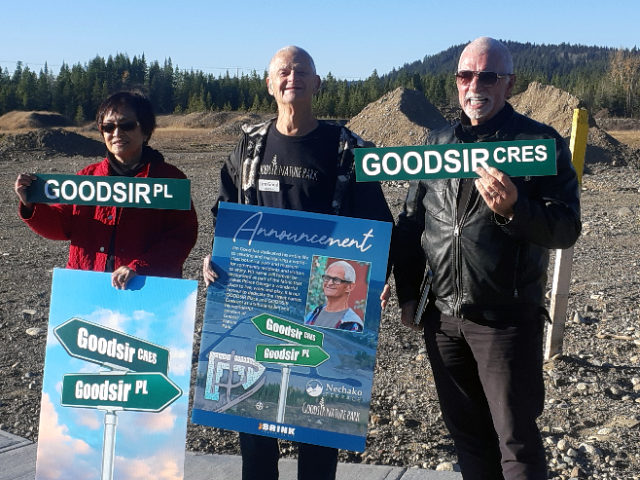 Property developer John Brink, right, presents street signs named after Jim Good, centre, the curator of Goodsir Nature Park, standing next to his wife Reine. The signs will name streets that are part of the Nechako Terrace subdivision.