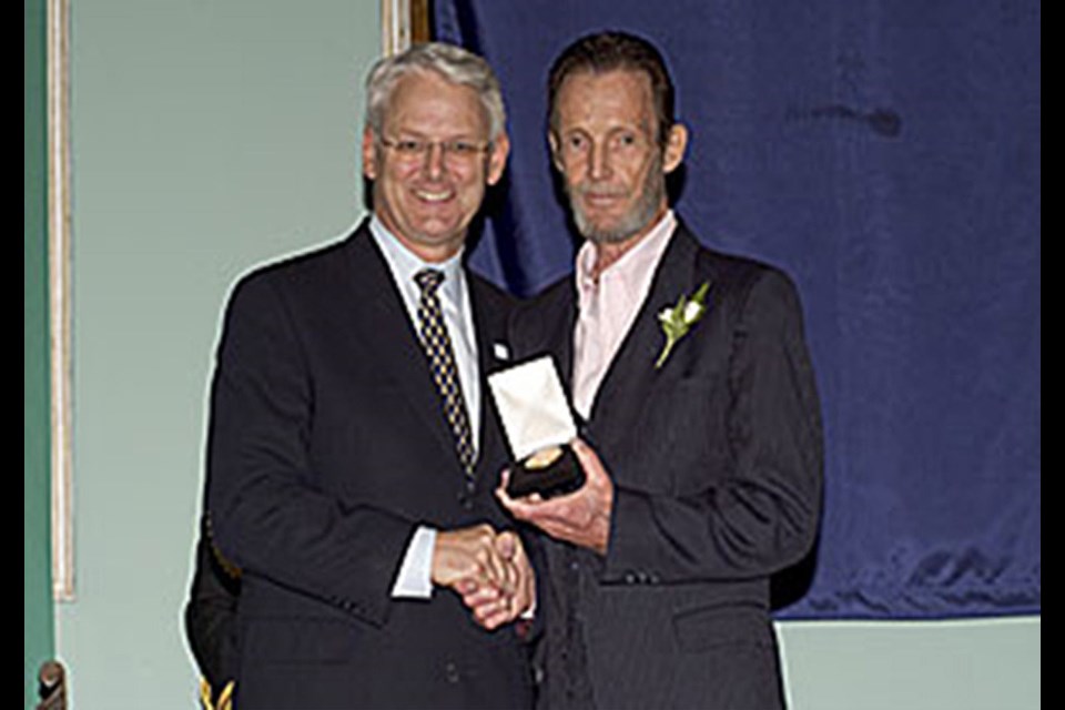 Former B.C. premier Gordon Campbell presents the British Columbia Community Achievement Award to Bob Scott in 2004. Scott founded the Drug Awareness Recovery Society in Prince George in 1996.