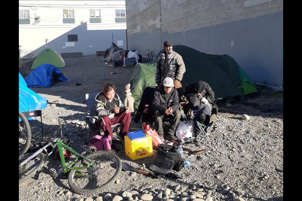 Jacqueline John, left, Dallas Calliou, sitting, and Jimmy Santos, standing, were at the empty lot across from the courthouse on George Street Thursday morning where there are plans for a community garden.