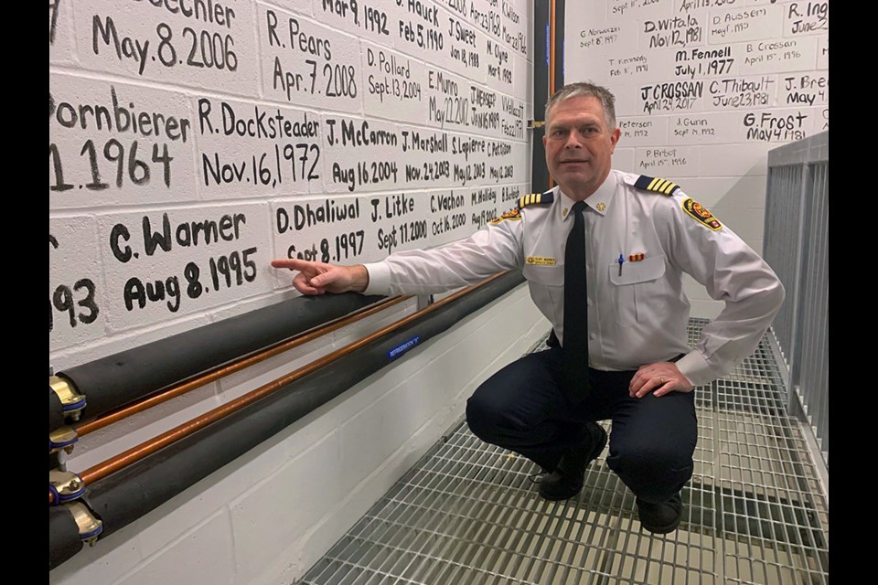 Prince George fire chief Cliff Warner points to the date he started with Prince George Fire Rescue, which is written on the hose tower wall of the No.1 fire hall on Massey Drive. Warner is retiring May 30 after a 30-year career as a firefighter.
