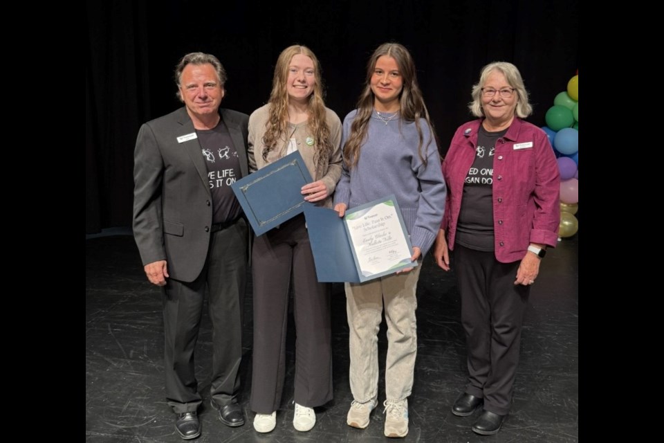 Rick and Noreen Woodward present the Transport BC scholarship to Duchess Park students Emily Clarke, second from left, and Kallista Nolte at the school's awards ceremony on Thursday, June 12, 2025.
