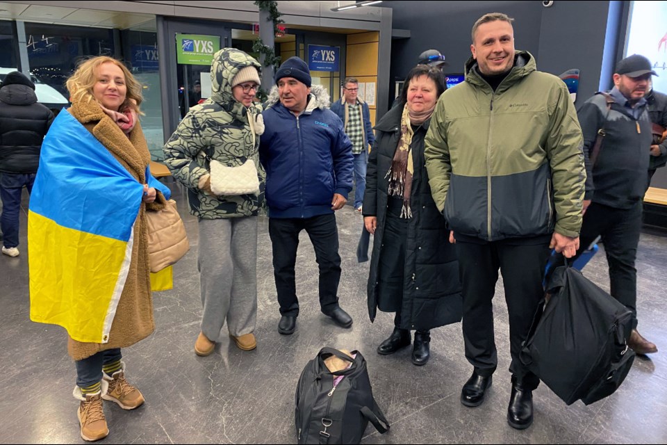 Svitlana Pavenska (holding flag) and Okeksiy Pavensky (her husband at far right), who fled to Prince George from Ukraine last year, greet Palenska's parents Serhiy (in blue jacket) and Olga Shadura after they arrived at Prince George Airport just before Christmas.  