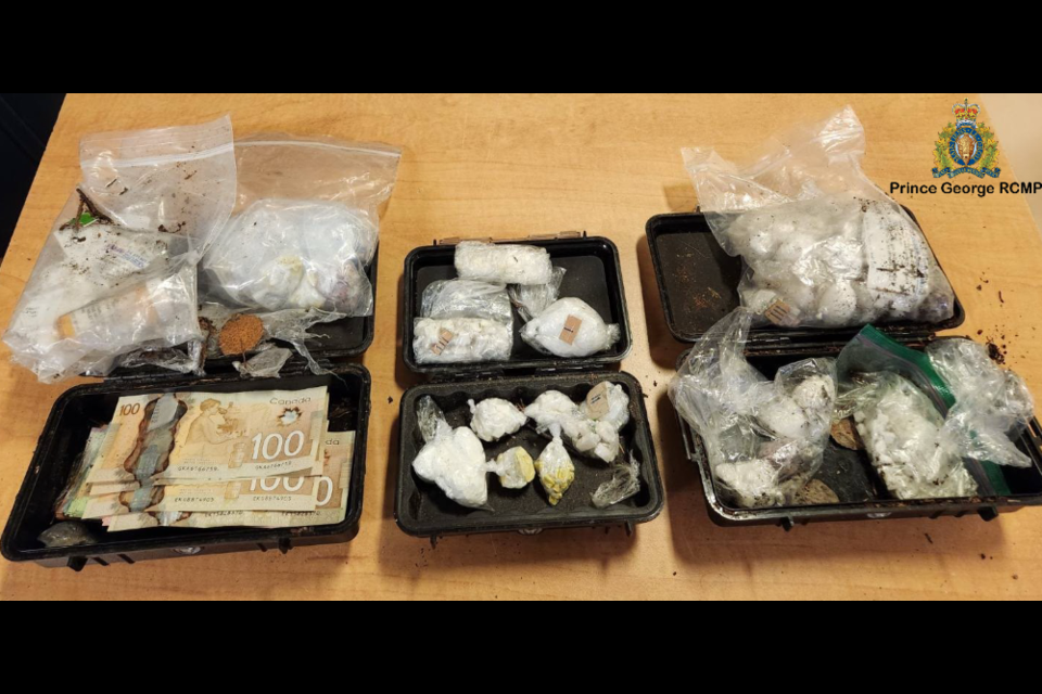 These are the drugs and cash found in black cases buried along a trail in Prince George.