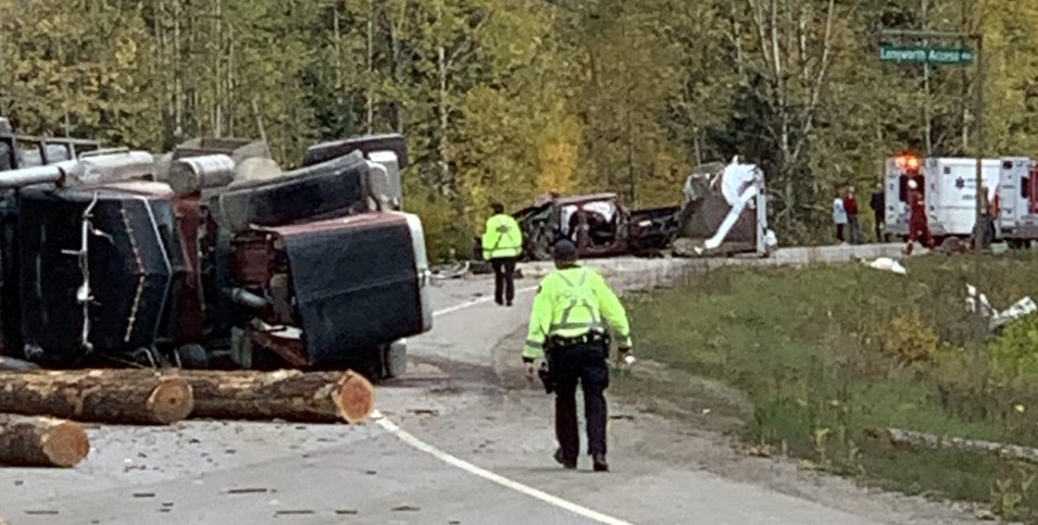logging truck and pickup with horse trailer