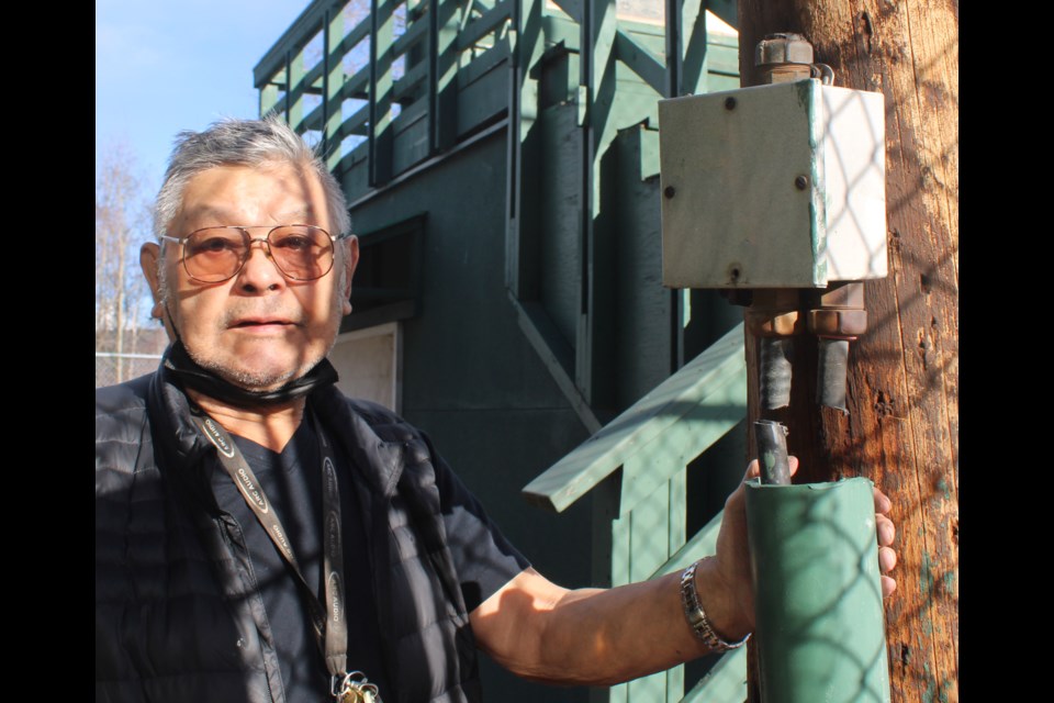 Peter Ghostkeeper shows one of the spots where a cable was cut in an apparent attempt to steal copper at the Spruce City Men's Fastball diamond.