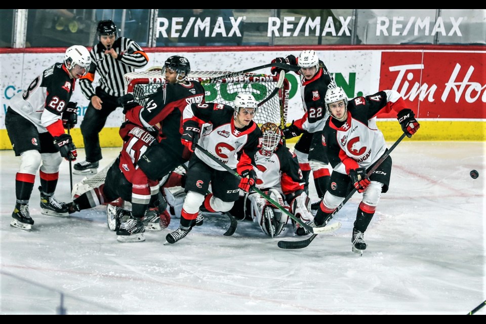 Cougars goaltender Taylor Gauthier draws a crowd as he awaits a shot on goal during Thursday's 3-0 win over the Vancouver Giants in the WHL hub in Kamloops. Gauthier made 26 saves for his first shutout of the season. 