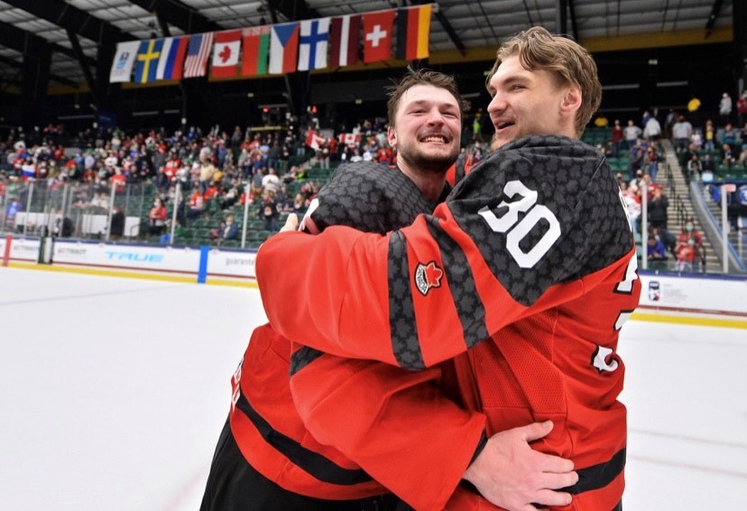 Prince George Cougars goalie Tyler Brennan, right, hugs goalie Ben Gaudreau as they celebrate Team Canada's 5-3 win over Russia in the gold-medal game at the 2021 IIHF U-18 World Hockey Championship last Thursday in Frisco,, Texas.