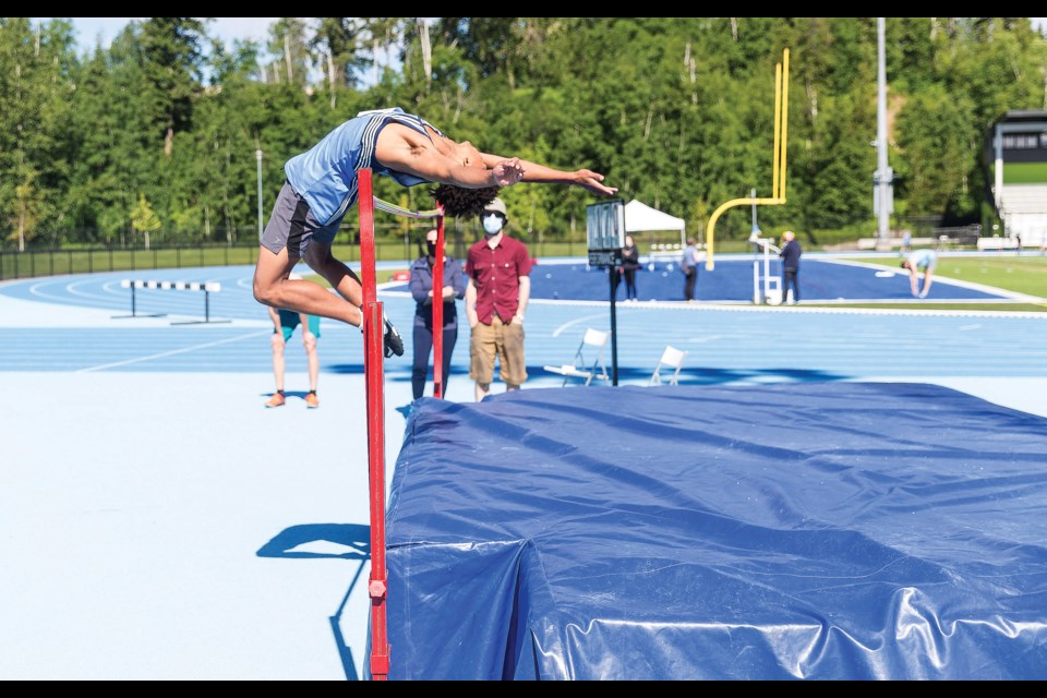 Citizen Photo by James Doyle/Local Journalism Initiative. Bobby Kelly clears the high-jump bar on Saturday morning while competing in the Spruce City Invitational track and field meet at Masich Place Stadium.