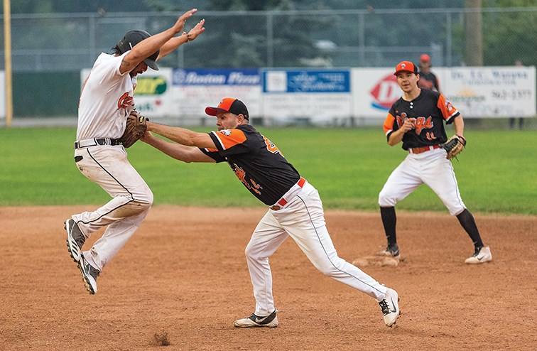 Big Guy Lake River Kings player Randy Potskin makes the tag against the STK Orioles at Spruce City Stadium in the championship game of the John Cho Cup.