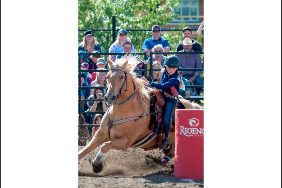 Ainslee Meise, nine years old, takes on another barrel with her horse Speedle. Ainslee won her race.