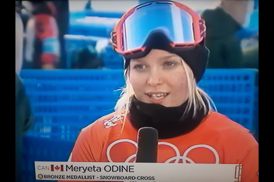 Meryeta O'Dine of Prince George gets interviewed by a CBC TV reporter after she won the bronze medal in women's snowboard cross Wednesday at the Beijing Olympics in Zhangjiakou, China.
