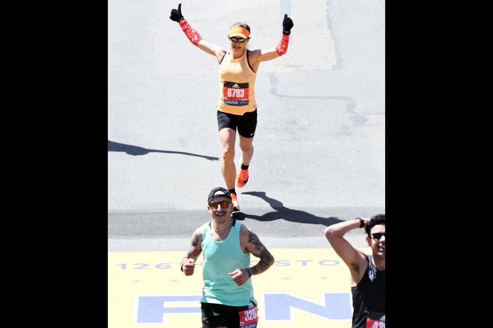 Jacqui Pettersen of Prince George crosses the Boston Marathon finish line Monday, placing seventh in the women's 50-54-year-old age division.