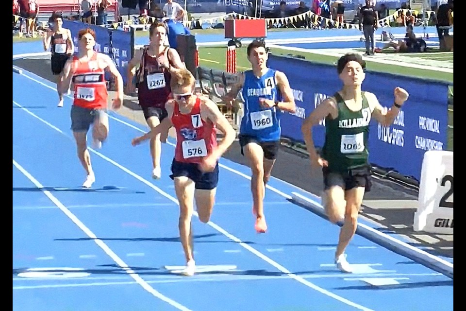 Noah Gladdish, red shirt at left, crosses the finish of the senior boys 800m event at the 2025 BC Secondary School provincial track and field championships Saturday in Langley. Gladdish was ninth out of 32 runners in the event.