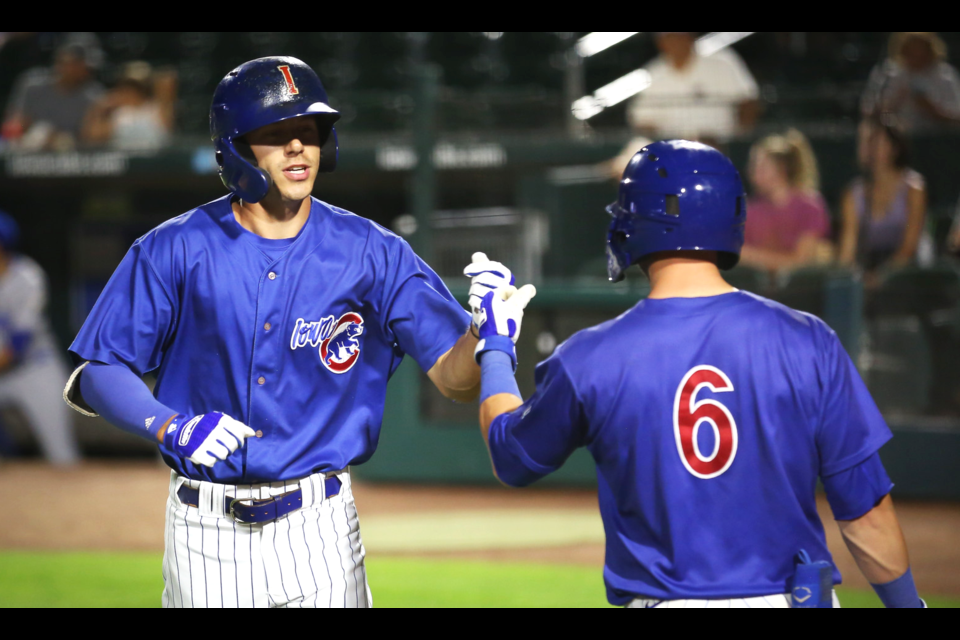Jared Young, left, offers a fist-pump to his Iowa Cubs teammate Trent Giambrone during a game last week in Des Moines, Iowa against the Omaha Storm Chasers.