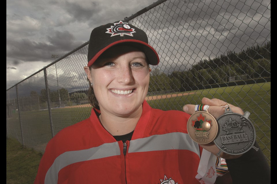 Amanda Asay in 2012 holds her silver medal from the Canadian national baseball championship and bronze medal from the Women's Baseball World Cup. 