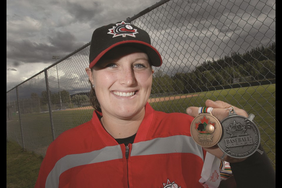 BC Sports Hall of Fame member Amanda Asay holds her silver medal from the 2012 Canadian national baseball championship and bronze medal from the Women's Baseball World Cup. 