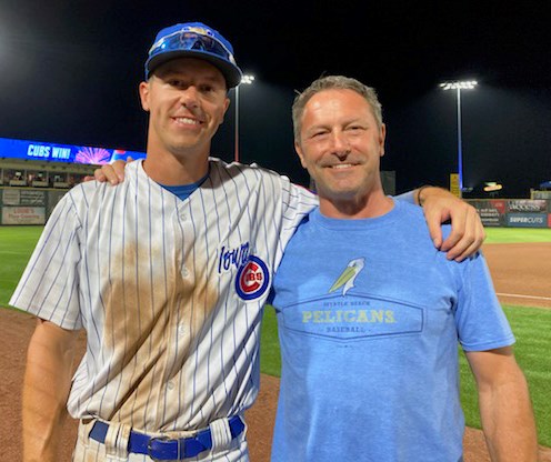 Jared Young and his dad Randy strike a pose after one of Jared's games in August in Des Moines, Iowa. The Chicago Cubs called up Jared to play for them Wednesday against the Mets in New York.