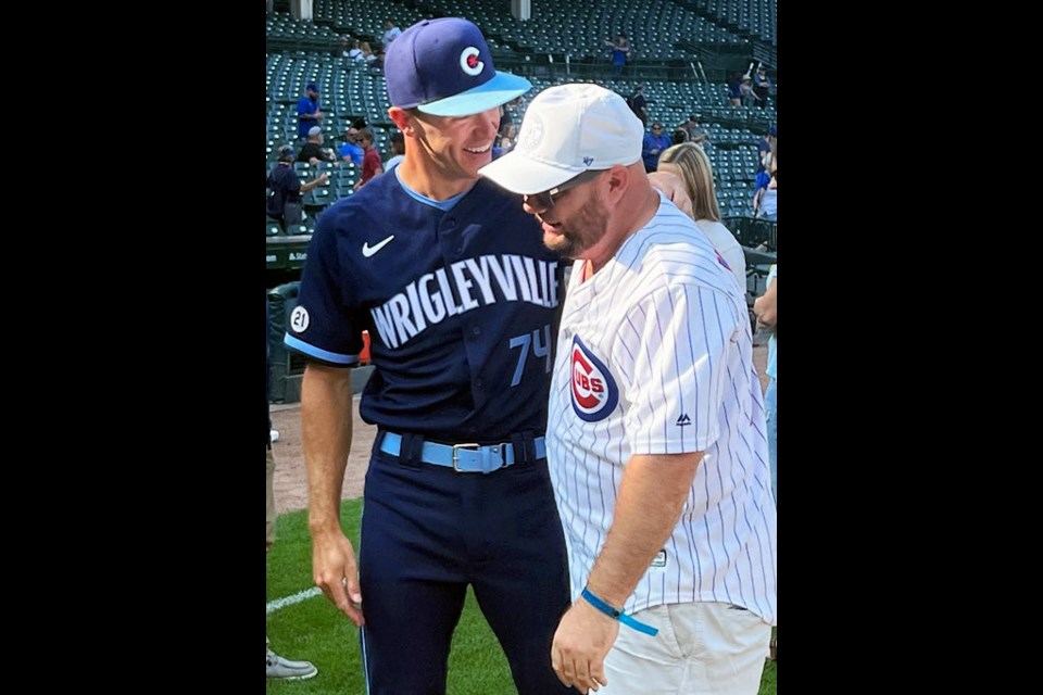 Jared Young shares a laugh with his brother Tanner after he made his major league debut with the Chicago Cubs, Sept. 16, 2022 at Wrigley Field.