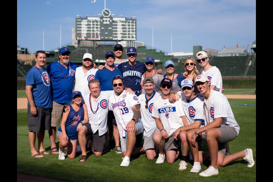 Chicago Cubs infielder Jared Young, top row centre, shares a post-game moment at Wrigley Field in Chicago with his friends and family from Prince George after he helped the Cubs beat the Colorado Rockies 2-1 on Friday. 