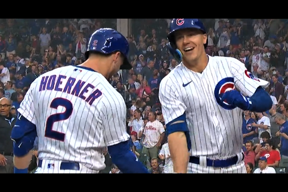 Jared Young is met at home plate by his Chicago Cubs teammate Nico Hoerner after Young hit his first career major league home run July 28 in Chicago against the Philadelphia Phillies.