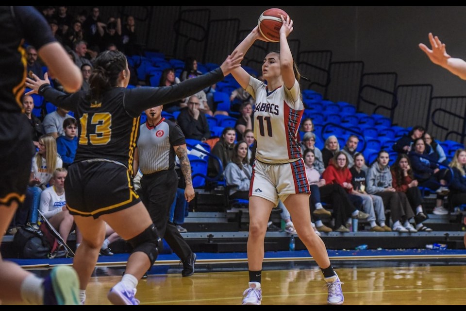 Nevena Nogic of the Sa-Hali Sabres considers her options with the ball while being watched by Duchess Park Condors defender Devyn Bjorn during their semifinal game Friday, Feb. 28, 2025 at the BC triple-A girls basketball provincial championship in Langley. 