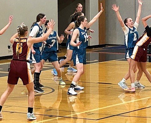 The Cedars Christian Eagles pour on the defence to try to stop the King's Christian Thunder in the fifth-place game at the BC single-A girls basketball provincial championship in Langley, March 1, 2025.