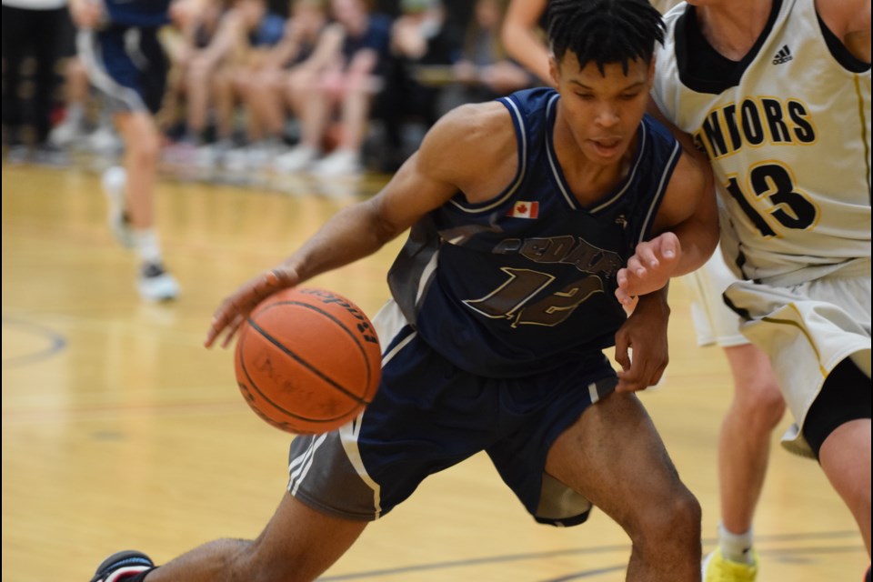 Tony Kibonge of the Cedars Christian Eagles runs into Duchess Park Condors defender Evgeny Baukin as he takes the ball to the net during Wednesday's City League final at Duchess Park gym.