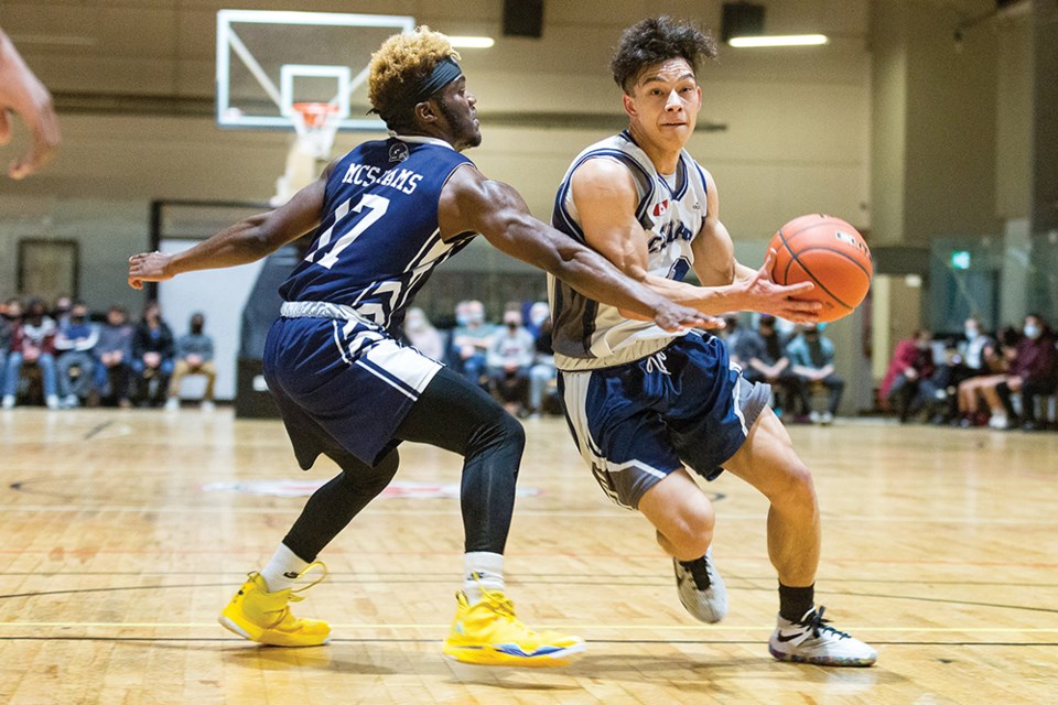 Seth Hulka of the Cedars Christian School Eagles caries the mail while being guarded by Jos Scott of the Mountain Christian Rams Thursday at the North Central zone single-A boys basketball tournament at the PG Dome. The Eagles downed the Sir Alexander Mackenzie Grizzlies 91-47 on Friday.
Citizen file photo