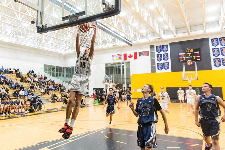 Duchess Park Condors forward Evgeny Baukin dunks the ball after sneaking behind the Cedars Christian Eagles' defence,  including Mitch Crosina (6), Jakob Oliver (13) ad Zack Wagner (7). Baukin had 17 points in a 92-61 victory Friday night at Duchess Park Secondary School.
Citizen Photo by James Doyle. 