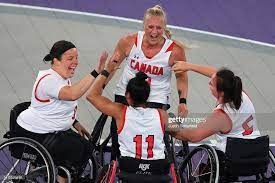 Former UNBC Timberwolf Kady Dandeneau of Pender Island, facing camera, celebrates with her Canadian teammates after they won the gold medal in women's 3X3 wheelchair basketball Tuesday at the Commonwealth Games in Birmingham, England.