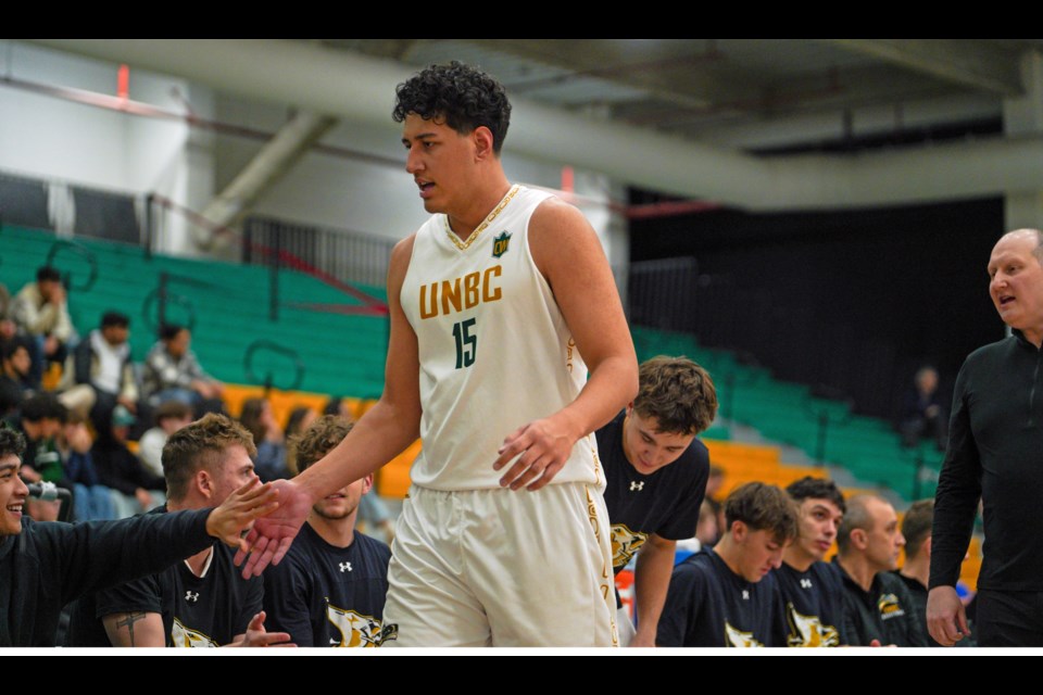 UNBC forward Wesley Ainu'u gets a welcome from his Timberwolves teammates as he comes ti the bench for a breather during Friday's game against the Fraser Valley Cascades at the Northern Sport Centre.