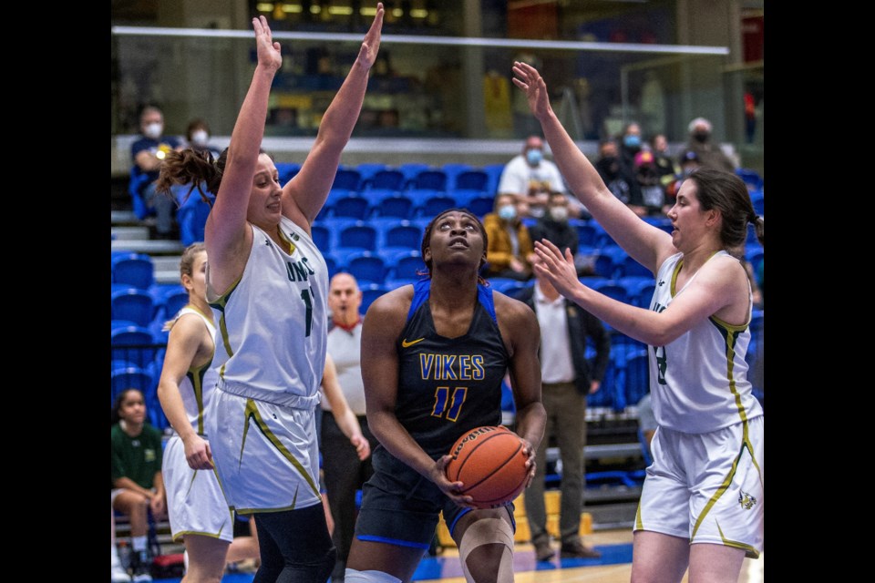 Mimi Sigue of the UVic Vikes draws the attention of UNBC's Sveta Boykova, left, and Rebecca Landry during their U SPORTS Canada West women's basketball game Saturday in Victoria.