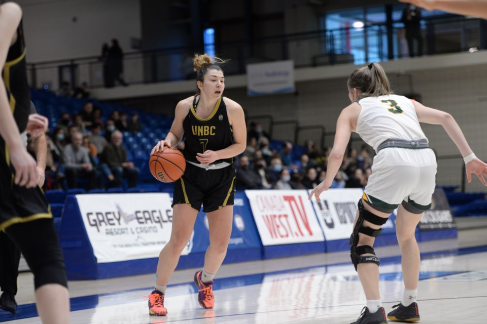 Alina Shakirova of the UNBC Timberwolves directs traffic as she hold the ball during their second-round Canada West playoff game Saturday in Calgary against the Regina Cougars. The Cougars advanced after a 77-66 win.