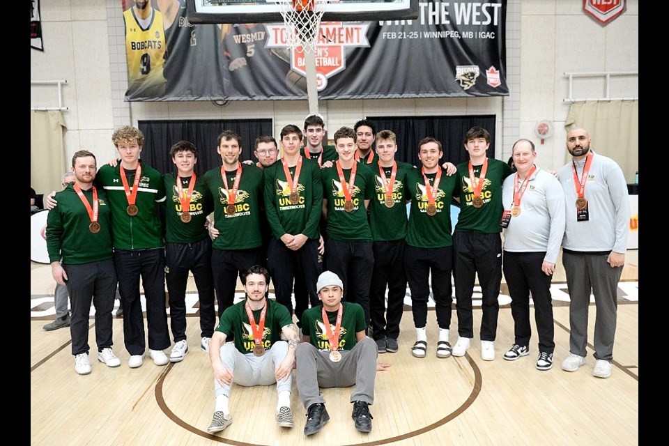 The UNBC Timberwolves celebrate their bronze medal win at the Canada West men's basketball championship Sunday in Winnipeg.